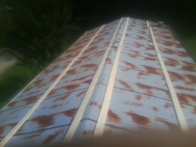 Rusted metal roof panels with new wood purlins before replacement — Storm Damage Roof Repair in Gardiner by Roofing Brothers